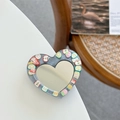 Detail of heart-shaped phone grip with glitter mirror and colorful fruit slice accents - Silver Gray