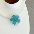 Close-up of a floral glitter phone socket on a desk with a coffee cup in the background - Ink Blue