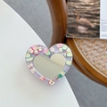 Detail of heart-shaped mirror phone grip with purple resin and colorful fruit slices - Purple