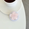 Detail of pink glitter sakura flower phone grip with magnetic base on white desk - Pink