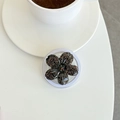 Close-up of a 3D glittery cherry blossom phone grip on a minimalist white desk surface - Black