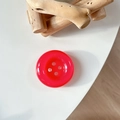 Macro shot of a red round resin button phone stand on a white minimalist background - Crystal Rose Red