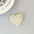 Support téléphone cœur avec nœud en perles et strass sur surface en nacre - Support Transparent - Cœur en Coquille - No. 17 Grand Nœud Perlé