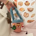 Detail of pink knitted Christmas bag featuring reindeer and Santa Claus plush 3D decorations - Pink
