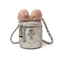 Silver quilted bucket bag with a large pink bow decoration and metallic chain strap - Silver