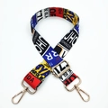 Close-up of adjustable wide woven bag strap with colorful license plate pattern print - No. 338 Graffiti Letters (Gold Buckle)