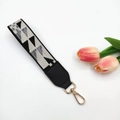 Wide woven bag strap with geometric pattern and gold metal clasp in flat lay view - Geometric Triangle