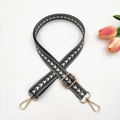 Detail of adjustable nylon bag strap with white V-pattern and gold lobster clasps - Dark Gray