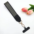 Macro view of phone lanyard wrist strap with V-shaped pattern and gold metal clasp - Light Gold Arrow / With Gasket