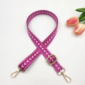 Close-up of adjustable purple nylon bag strap with white chevron patterns and gold buckles - Rose Pink