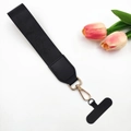 Detailed view of black woven wrist strap with gold metal lobster clasp and phone patch - Solid Black Nylon / With Gasket