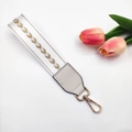 Close-up of heart embroidered strap with golden metal lobster clasp and leather joints - White Gold Arrow / Standard Type