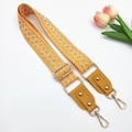 Detail of adjustable orange embroidered bag strap with geometric waves and gold metal clips - Yellow