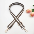 Macro detail of adjustable brown and white rainbow strap with polished gold hardware - Light Coffee Striped