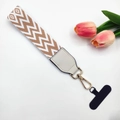 Close-up of woven phone wrist strap with white leather connector and gold snap hook - Khaki Wave / With Gasket