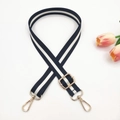 Macro shot of black and white striped woven strap with gold metal lobster clasps - Black & White Stripes