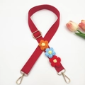 Detail showing the adjustable red canvas bag strap with colorful hand-woven flowers - Gold Clasp / Red Strap With Multi-color Flowers