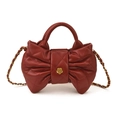 Quilted bow-shaped handbag in deep red leather with camellia gold clasp and chain strap - Red