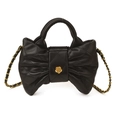 Elegant black quilted handbag with bow shape and golden camellia metal clasp detail - Black