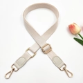 Detail of adjustable beige cotton strap with light gold hardware and grey leather parts - Gold Buckle / 3-Off-white