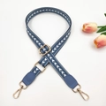 Macro view of adjustable woven strap with white arrow pattern and gold-tone metal hardware - Lake Blue + Lake Blue Leather