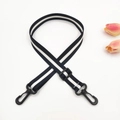 Detail of adjustable black and white striped shoulder strap with plastic swivel hooks - Black + Black Buckle