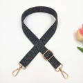 Close-up of woven ethnic bag strap with geometric jacquard and gold metal buckles - Gold Buckle / Dark Grey Large V Pattern