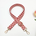 Detail of red and white geometric jacquard strap with adjustable golden metal hooks - Red White Small V Pattern