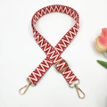 Detail of adjustable 2.5cm woven strap with red geometric patterns and gold lobster clasps - Red White Large V Pattern