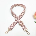 Close-up of adjustable woven bag strap with red geometric pattern and gold clasps - Wine Red Small V Pattern