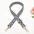 Close-up of black and white bohemian woven bag strap with golden metal lobster clasps - Dark Blue Small V Pattern