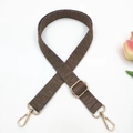 Detail view of woven adjustable bag strap with jacquard pattern and golden buckles - Dark Khaki Large V Pattern