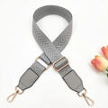 Detailed view of adjustable 3.8cm light grey strap with woven chevron pattern and gold metal - Light Gray