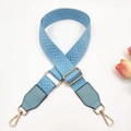 Macro view of light blue chevron woven bag strap with golden hardware and leather detail - Light Blue