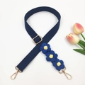 Detail showing deep blue woven bag strap with handmade crochet flowers and gold hardware - Gold Buckle / Dark Blue
