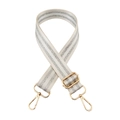 Detail of adjustable cream fabric shoulder strap with silver stripes and gold hardware - White