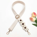 Detail of hand-crocheted floral ornaments on adjustable beige fabric crossbody strap - Off White