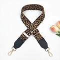 Detail of adjustable leopard print bag strap with gold metal hooks on white background - Gold Buckle / Mixed Brown Leopard + Black Leather