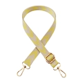Close-up of yellow and white chevron pattern canvas strap with gold metal buckles - Beige and Yellow