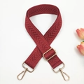 Close-up of wine red woven strap with gold hardware and geometric herringbone pattern - Gold Buckle / Burgundy