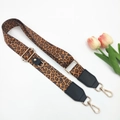 Close-up of leopard print bag strap with gold lobster clasps and black leather details - Brown Leopard Single Strap