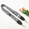 Close-up of leopard print polyester strap with adjustable gold hooks and black leather - White Leopard Black Leather End Single Strap