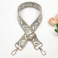 Detailed macro view of embroidered floral wide bag strap with light gold metal swivel hooks - Gold Buckle / Style 4-Beige & Matcha Green