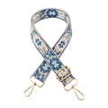 Detail view of ethnic floral embroidery on a wide shoulder strap with golden metal hardware - 12-Beige Base Lake Blue
