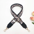 Detail of jacquard woven bag strap with pink leaf pattern and gold metal lobster clasps - Black Pink + Black Leather