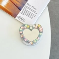 Detail of heart-shaped phone grip featuring mirror surface and colorful fruit charms - Pearl Silver Gray