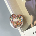 Macro shot of a sparkling heart phone grip with colorful sequins and handmade label - Magnetic Colorful Sequin Heart Style No.5