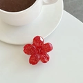 Detail van rode bloem telefoonhouder met gouden glitters op een witte tafel - Rood (Glitter)