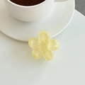 Detail of yellow flower phone grip with glitter resin finish on a white desk - Yellow (Glitter)