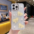 Close-up of clear glitter phone case featuring yellow resin bows and white pearls - iPhone 7/8/SE 2020 / Yellow
